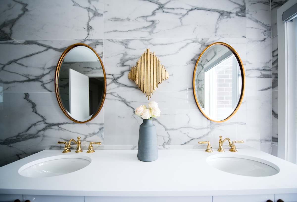 Marble powder room with gold fixtures